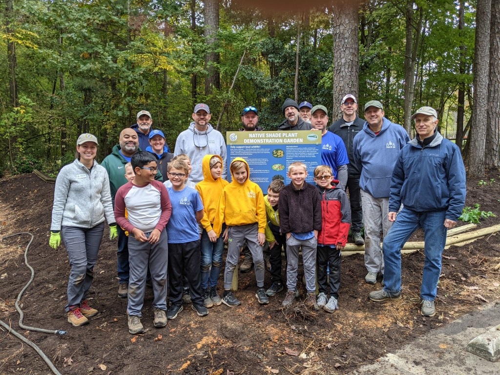 Group photo by new garden sign